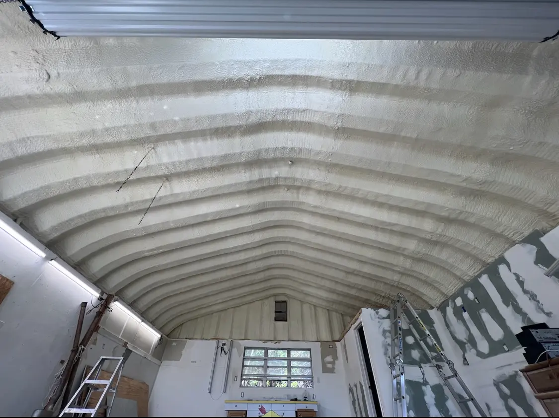 Spray polyurethane foam applied to the underside of a metal roof deck in Green